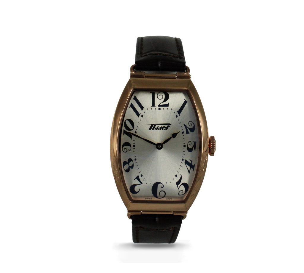 Elegante Tissot Heritage Porto: roségouden kast, zilveren wijzerplaat, bruine leren band, tijdloze stijl, Swiss Made. Verkrijgbaar bij Optiwatch.